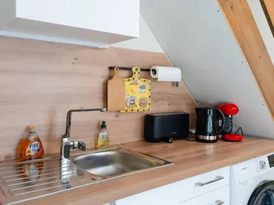 a kitchen with a sink in a tiny house at Villa T3 à Gruissan avec climatisation et jardin - FR-1-409A-36 in Gruissan