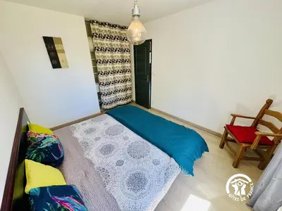 a small bedroom with a bed and a chair at Nore & nature in Pradelles-Cabardès