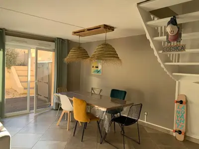 a dining room with a table and chairs at La Petite Villa du Soleil in Lavalette