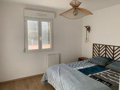 a bedroom with a bed and a window at La Petite Villa du Soleil in Lavalette