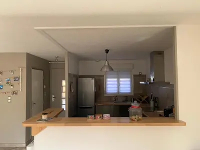 a kitchen with a counter top and a kitchen island at La Petite Villa du Soleil in Lavalette