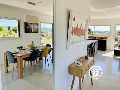a dining room and kitchen with a table and chairs at Le moulin de maquens in Carcassonne