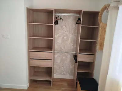 a closet with wooden shelves and a shower at Le moulin de maquens in Carcassonne