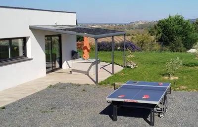 a ping pong table in the backyard of a house at Le moulin de maquens in Carcassonne