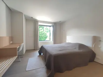 a white room with a bed and a window at Séjour d'exception au Moulin de la Vernède avec piscine, ruisseau, climatisation et parking in Conques-sur-Orbiel