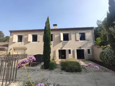 a large house with a tree in front of it at Séjour d'exception au Moulin de la Vernède avec piscine, ruisseau, climatisation et parking in Conques-sur-Orbiel
