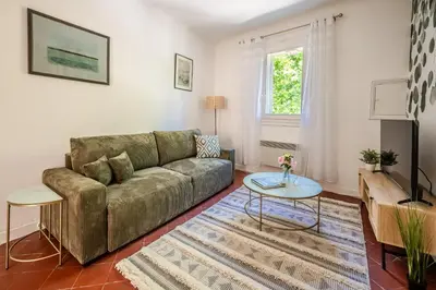 a living room with a couch and a table at Narbonne Rooftop apt in Narbonne