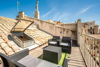 a balcony with chairs and a roof at Narbonne Rooftop apt in Narbonne