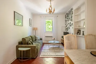 a living room with a couch and a table at Narbonne Rooftop apt in Narbonne