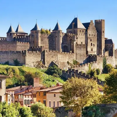 a large castle sitting on top of a hill at Studio Cosy proche Cité Centre WiFi in Carcassonne