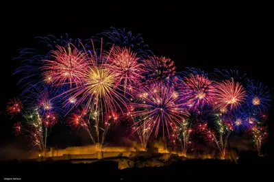 a group of fireworks exploding in the night sky at Studio Cosy proche Cité Centre WiFi in Carcassonne