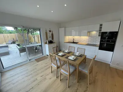 a kitchen and dining room with a table and chairs at Le Gite Hector in Carcassonne