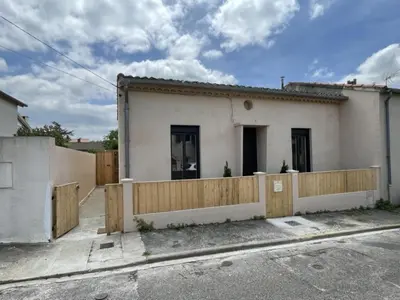 a house with a wooden fence in front of it at Le Gite Hector in Carcassonne