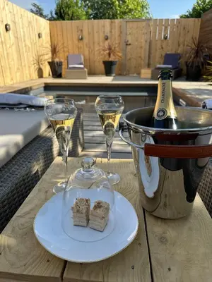 two glasses of wine and a plate of food on a table at Le Gite Hector in Carcassonne