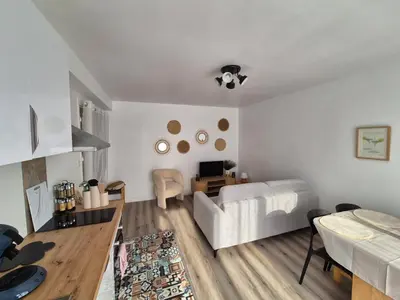 a living room with a white couch and a table at Loni in Carcassonne
