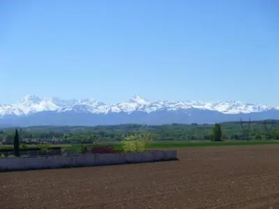 a view of snow covered mountains from a field at Loni in Carcassonne