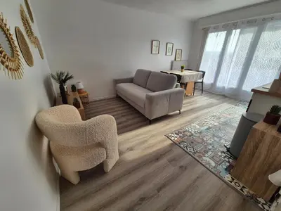 a living room with a couch and a chair at Loni in Carcassonne