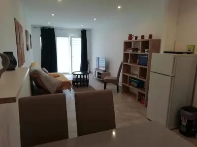 a person sitting on a couch in a living room at Charming house in a great location in Narbonne
