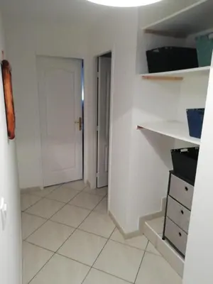 a hallway with a door and a tiled floor at Charming house in a great location in Narbonne