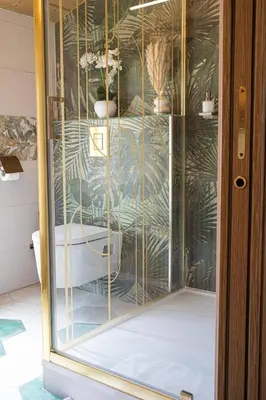 a glass shower in a bathroom with plants at Loft & Spa Scandinave Romantique, King Size, TV 65 in Narbonne