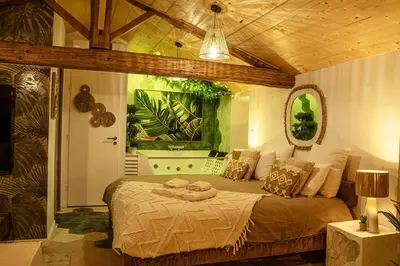 a bedroom with a large bed in a room at Loft & Spa Scandinave Romantique, King Size, TV 65 in Narbonne
