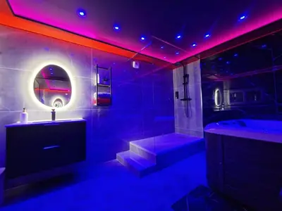a bathroom with a tub and a sink and a bath tub at Secret Night Pamiers in Pamiers