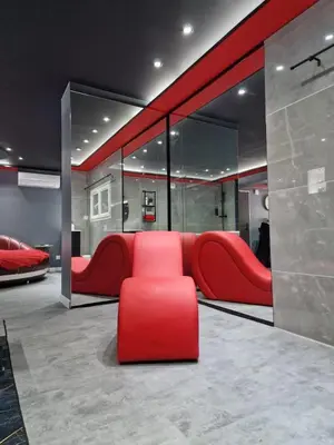a room with a red couch and a red chair at Secret Night Pamiers in Pamiers