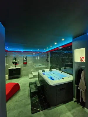 a bathroom with a jacuzzi tub in a room at Secret Night Pamiers in Pamiers