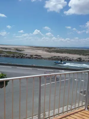 a view of a river with a boat in the water at Appt vue imprenable sur la mer in Gruissan
