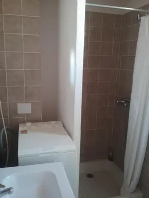 a bathroom with a toilet and a sink and a shower at Appt vue imprenable sur la mer in Gruissan