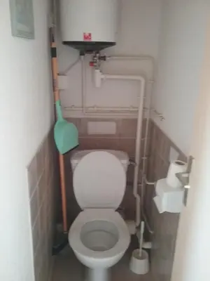 a small bathroom with a white toilet in a stall at Appt vue imprenable sur la mer in Gruissan
