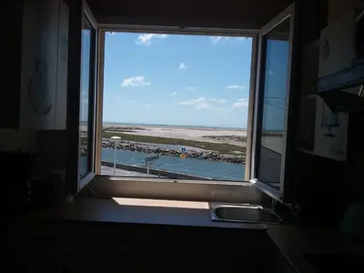 a window in a kitchen with a view of the ocean at Appt vue imprenable sur la mer in Gruissan