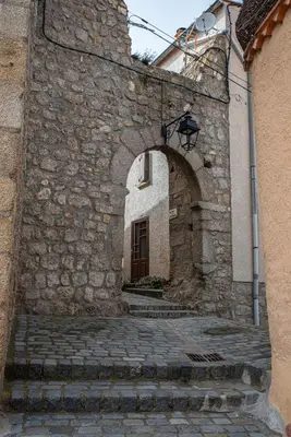an entrance to a stone building with an archway at Pure Canigou House An Authentic and Charming Town house with 3 bedrooms in Montalba-le-Château