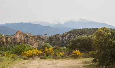 a dirt road in a field with mountains in the background at Pure Canigou House An Authentic and Charming Town house with 3 bedrooms in Montalba-le-Château