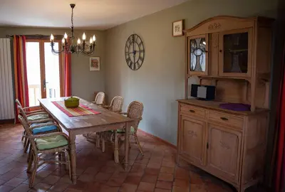 a dining room with a wooden table and chairs at Pure Canigou House An Authentic and Charming Town house with 3 bedrooms in Montalba-le-Château