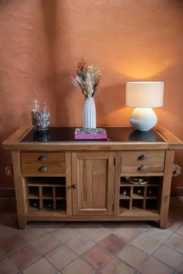 a table with a lamp and a vase on it at Pure Canigou House An Authentic and Charming Town house with 3 bedrooms in Montalba-le-Château