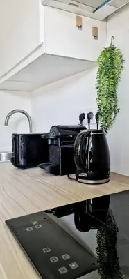 a black appliance sitting on a counter in a kitchen at N3-Barbacane-Pieds Cité-Clim mobile in Carcassonne