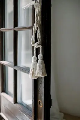 a tassel on a door with a window at Steinhaus mit Dachterrasse und Badefluss in Ribaute