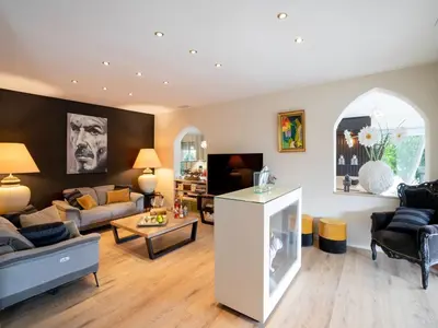 a living room with a couch and a table at Magnificent villa with private pool in Narbonne
