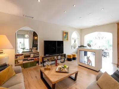 a living room with a television and a table at Magnificent villa with private pool in Narbonne
