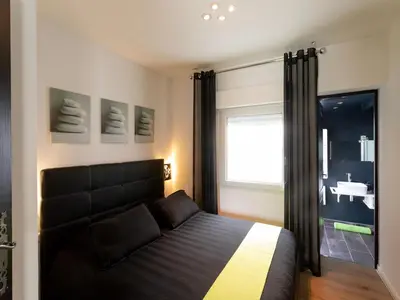 a bedroom with a large bed and a window at Magnificent villa with private pool in Narbonne