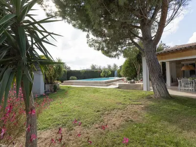 a garden with a swimming pool and a house at Magnificent villa with private pool in Narbonne