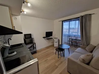a living room with a couch and a table at La Porte de la Mer in Port-la-Nouvelle