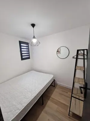 a bedroom with a bed and a ladder and a mirror at La Porte de la Mer in Port-la-Nouvelle