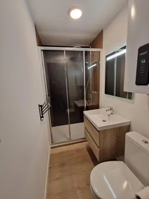 a bathroom with a shower and a toilet and a sink at La Porte de la Mer in Port-la-Nouvelle