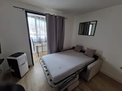 a hospital bed in a room with a window at La Porte de la Mer in Port-la-Nouvelle