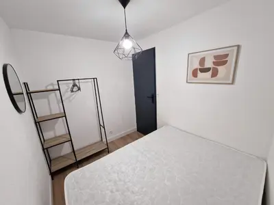 a bedroom with a bed and a ladder in it at La Porte de la Mer in Port-la-Nouvelle