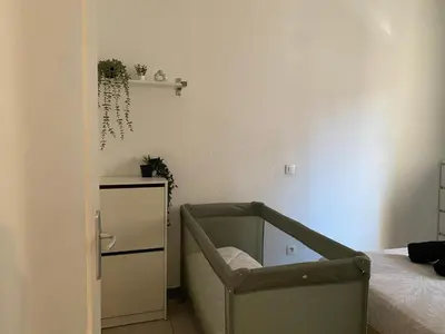 a bedroom with a bed and a chair in it at T2 contemporain centre ville in Narbonne