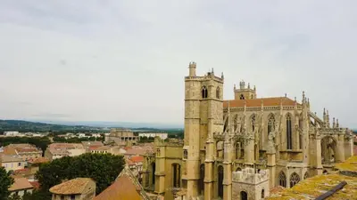 an old church with a tower in a city at T2 contemporain centre ville in Narbonne
