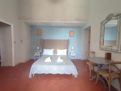 a bedroom with a bed and a table and a mirror at La Redorte 4 in La Redorte